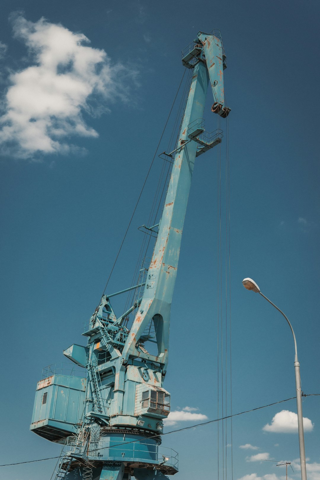 a-blue-crane-sitting-on-top-of-a-building-cm6ikm0snli